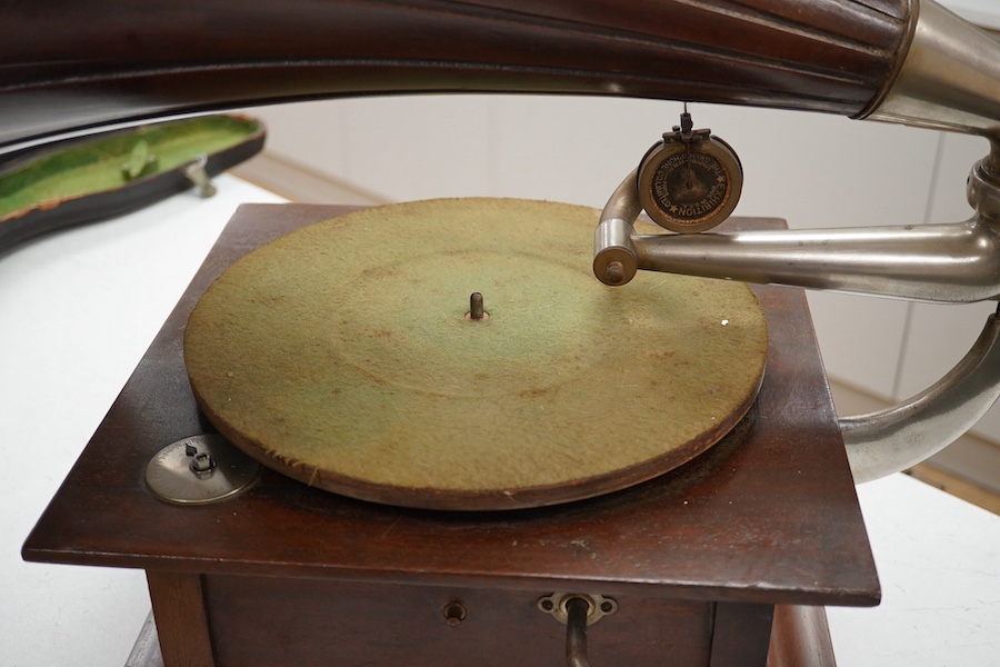 An HMV tabletop mahogany gramophone player with large laminated wooden horn, diameter of horn 55cm. HMV transfer labels to both body and horn. Condition - fair.